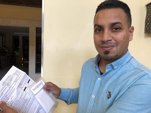Hussein Awami, a disease surveillance officer in Benghazi, holds a form used when specimens are sent to laboratories to be tested for polio
