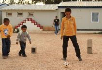 Three young boys playing football