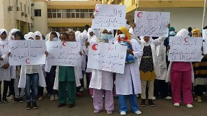 A_group_of_nurses_protesting_last_year_in_front_of_Sabha_Medical_Centre_following_an_assault_on_a_nurse._One_of_the_banners_reads_There_is_no_respect_for_those_working_at_Sabha_Medical_Centre