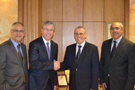 Dr Alwan, WHO Regional Director for the Eastern Mediterranean, shakes hands with the Minister of Health of Morocco, H.E. Dr El Hussein El-Ouardi. On H.E.'s left is Dr Jaouad Mahjour of the Regional Office and on Dr Alwan's right is Mr Jilali Hazem, Director of Planning and Financial Resources, Ministry of Health, Morocco.