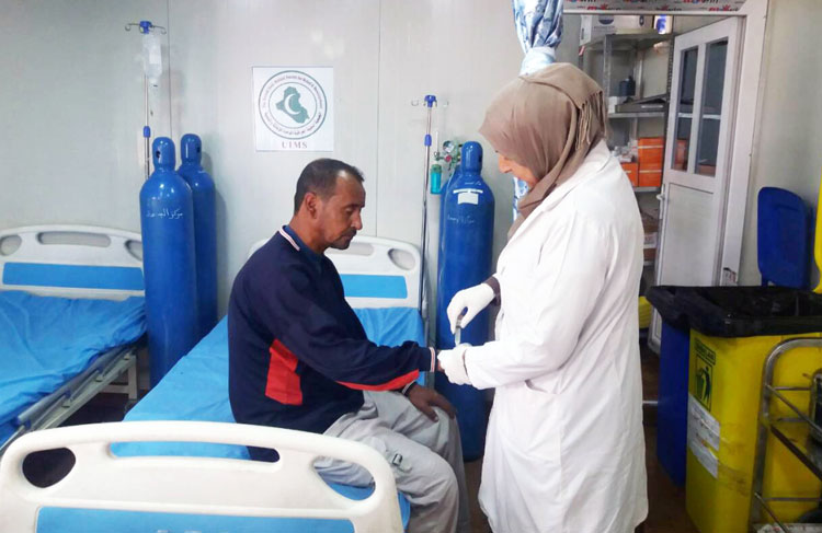 A male patient receives treatment at primary health care centre established by WHO in Ba’ja town