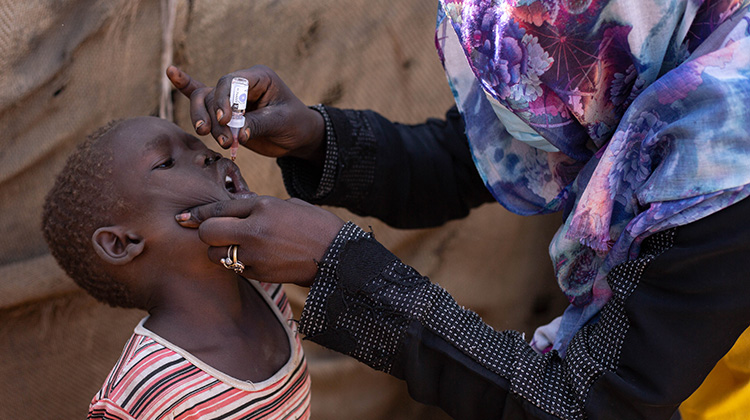 A child is given the oral polio vaccine during a polio vaccination campaign, Sudan, November 2020. Photo credit: WHO/WHO Sudan