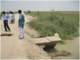 Surveying the damage on the Johi-Haji Khan road