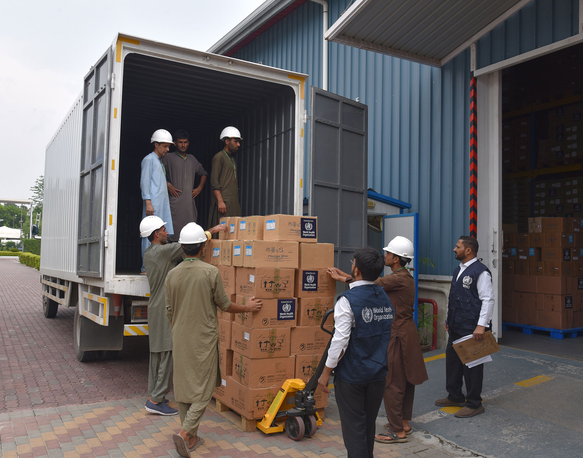 WHO teams load one of the trucks dispatched to preposition essential medical supplies. Photo credit: WHO/Hamid Inam