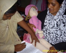 A photo of a woman being trained at a first-level care facility in Karachi, Sindh