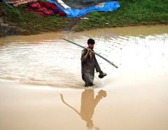 Here a man braves the flood water in Azakhel in Khyber Pakhtunkhwa during the floods in 2010