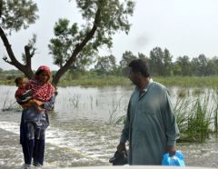 A family wade through the flood water in Kot addu-Multan district, Punjab