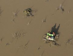 A family stranded by the flood water wait to be rescued in Pakistan in 2010