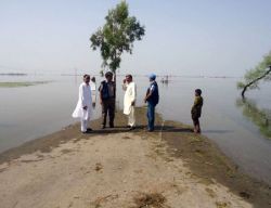 WHO surveillance officers visit a road blocked by floodwater in Sindh in 2012 