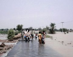 People navigate the roads submerged in water following flash floods in Rajanpur, Punjab, Pakistan.