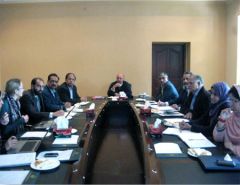 Dr Arif Nadeem and others around a table in a meeting room