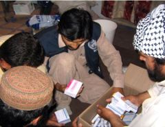 Health staff examining medicine boxes together