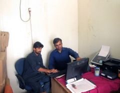 Health staff in an office around a computer