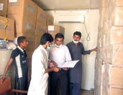 Health staff in a medicines warehouse