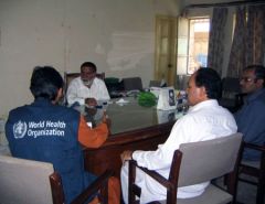 Health staff around a table at a meeting