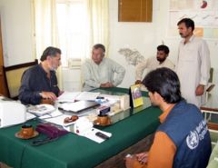 Health staff around a table at a meeting