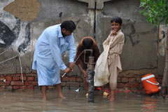Men use a hand pump in Badin, Sindh