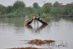 The remains of someone’s dwelling appears above the flood water in Badin, Sindh