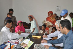 WHO staff meeting with the district health officer in a basic health unit in Thatta, Sindh 
