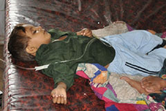 A child receives a drip in a civil hospital in Sanghar, Sindh