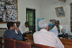 WHO staff meet with the district health officer in Sanghar, Sindh, to discuss health needs following the flood in 2011