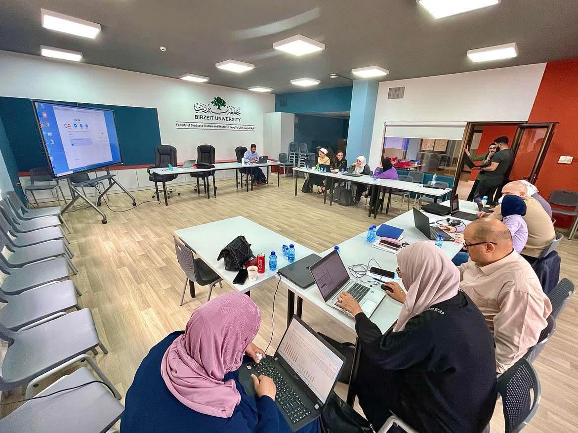 Faculty and participants engaged in an intensive workshop at Birzeit University's Faculty of Graduate Studies and Research, fostering collaboration and knowledge sharing.