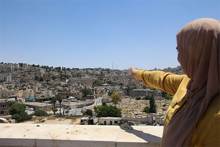 Aseel points towards the H2 area, which has seen multiple cycles of violence due to settlement activities. Residents of the H2 area often suffer from mental health issues caused by conflict and difficult life conditions. 