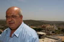 Abu Rami, village council member, coordinates medical cases with the Israeli authorities for sick people to leave the “Seam Zone” village of Barta’a