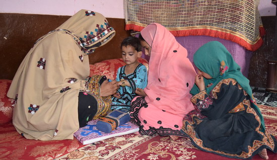 19-year-old vaccinator Shamima with her intricately embroidered notebook cover and carrier bags