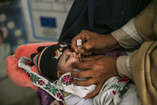 Majra Bibi gives polio drops to 10-day-old Bilal Khan at a health unit in Khyber Pakhtunkhwa province, Pakistan. 