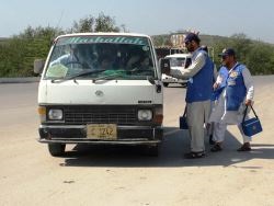 A permanent transit post team working at the Kohat Tunnel in Khyber Pakhtunkhwa province flag down cars to vaccinate children towards Afghanistan