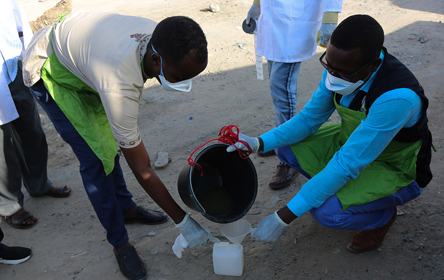 Environmental surveillance officers collect wastewater samples during the environmental surveillance activity in Mogadishu, Somalia.