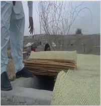 A water reservoir covered by locally produced straw mats.