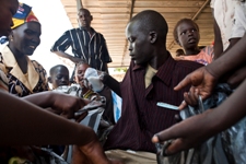 A photo of a treatment supporter from a nongovernmental organization distributing food baskets among patients and their families