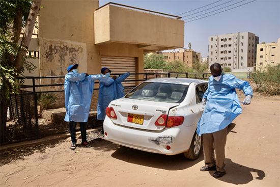 A COVID-19 rapid response team put on PPE as they prepare to respond to a COVID-19 alert in Khartoum. © WHO/Lindsay Mackenzie