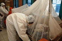 Health workers of Nyala teaching hospital ensuring that yellow fever patients are protected by mosquito nets to prevent mosquitoes from carrying the infection to other people.