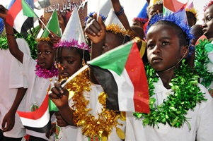 Children waving the Sudanese flag taking part in the World TB Day march in Khartoum