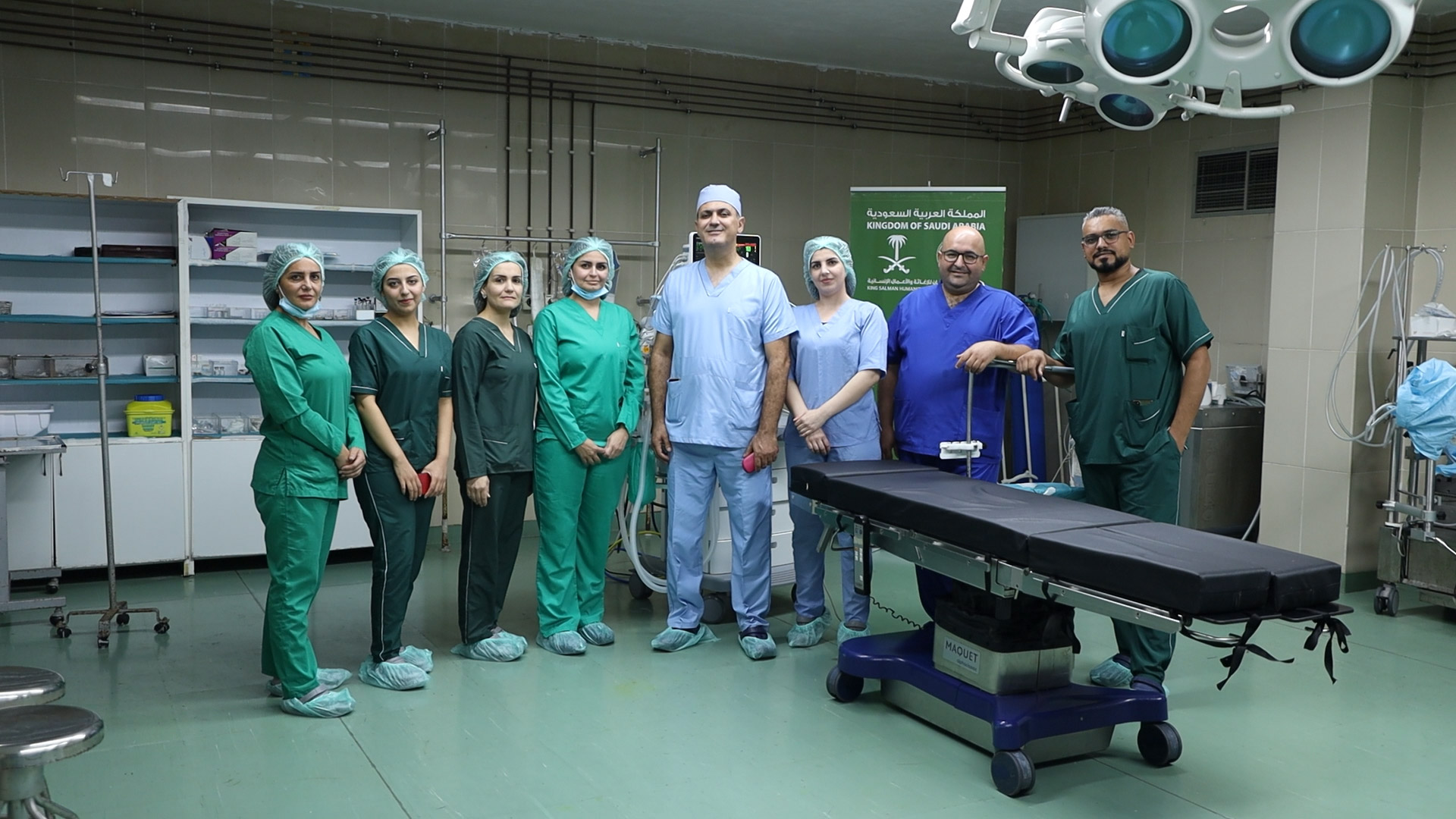A medical team stands beside the new operating table provided through KSrelief support. Photo credit: WHO