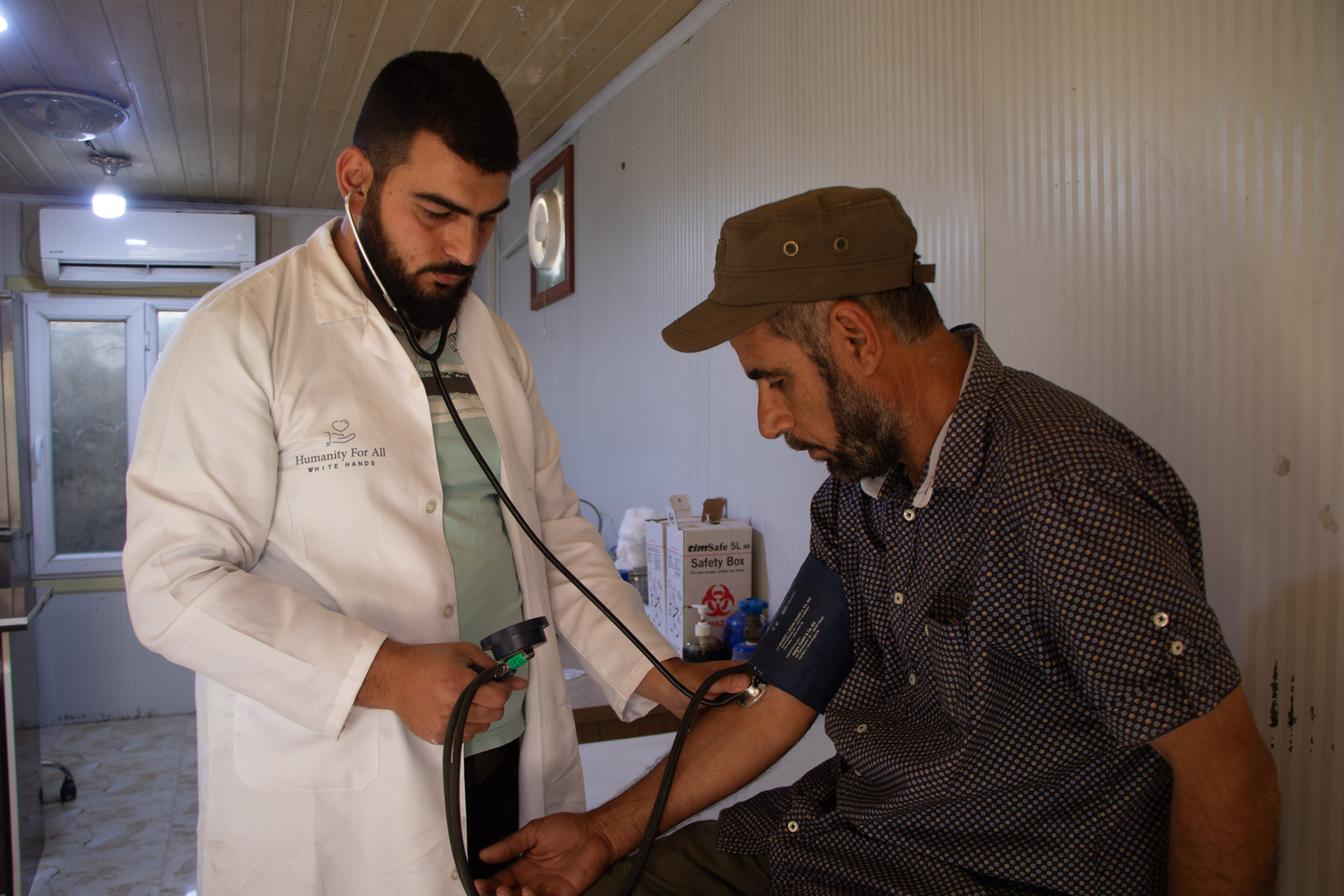 Abdul Muneem consulting with patients at Ehthimalat Health Centre, Aleppo. Photo: WHO