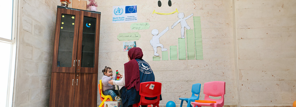 A health worker at Al-Birr Association health centre in Hama engages a young child in early stimulation activities as part of integrated mental health and psychosocial support services
