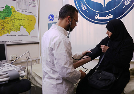 Om Bakri, 65, has her blood pressure checked at the Al-Birr Association health centre in Hama, where she brings her husband for regular treatment. Photo: WHO
