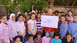 Elizabeth Hoff, WHO Representative in Syria, stands with children in the deworming campaign