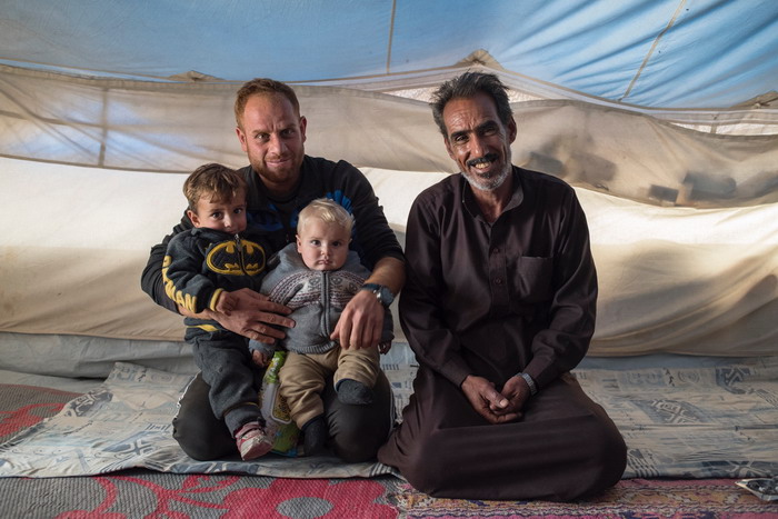 Nasser (right) and his son grandson and a friend in their tent in Ain Issa Camp