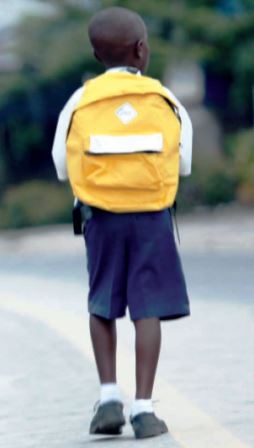Boy walking to school with satchel