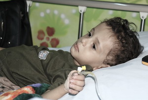 A young boy lying in a hospital bed