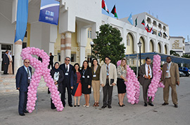 MOH Tunisia took the opportunity of convening the Regional Committee to launch an anti Breast cancer campaign. H.E. Misister of Healthof Tunisia with a group of participants with the pink ribbon; the anti breast cancer symbol