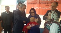 Minister of Public Health Dr Ferozuddin Feroz vaccinates a child during the NIDs inauguration ceremony