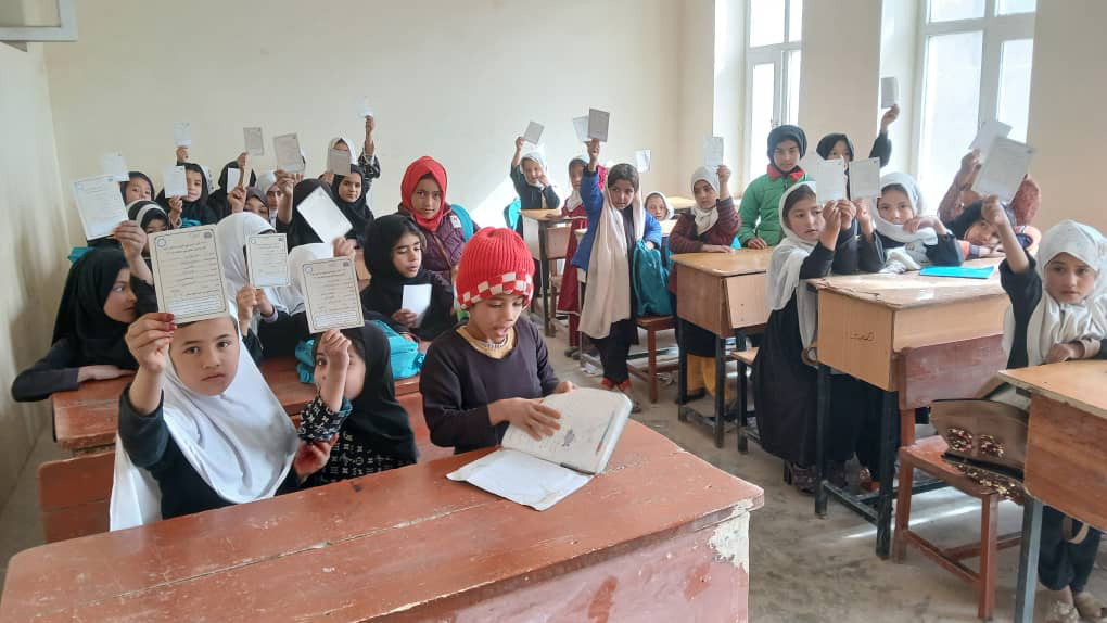 Schoolchildren proudly display their measles vaccination cards after receiving their doses during the 2nd phase of the nationwide measles immunization campaign. Protecting every child and leaving no one behind. Photo Credit: WHO Afghanistan