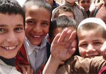 Group of young Afghani boys smiling at the camera