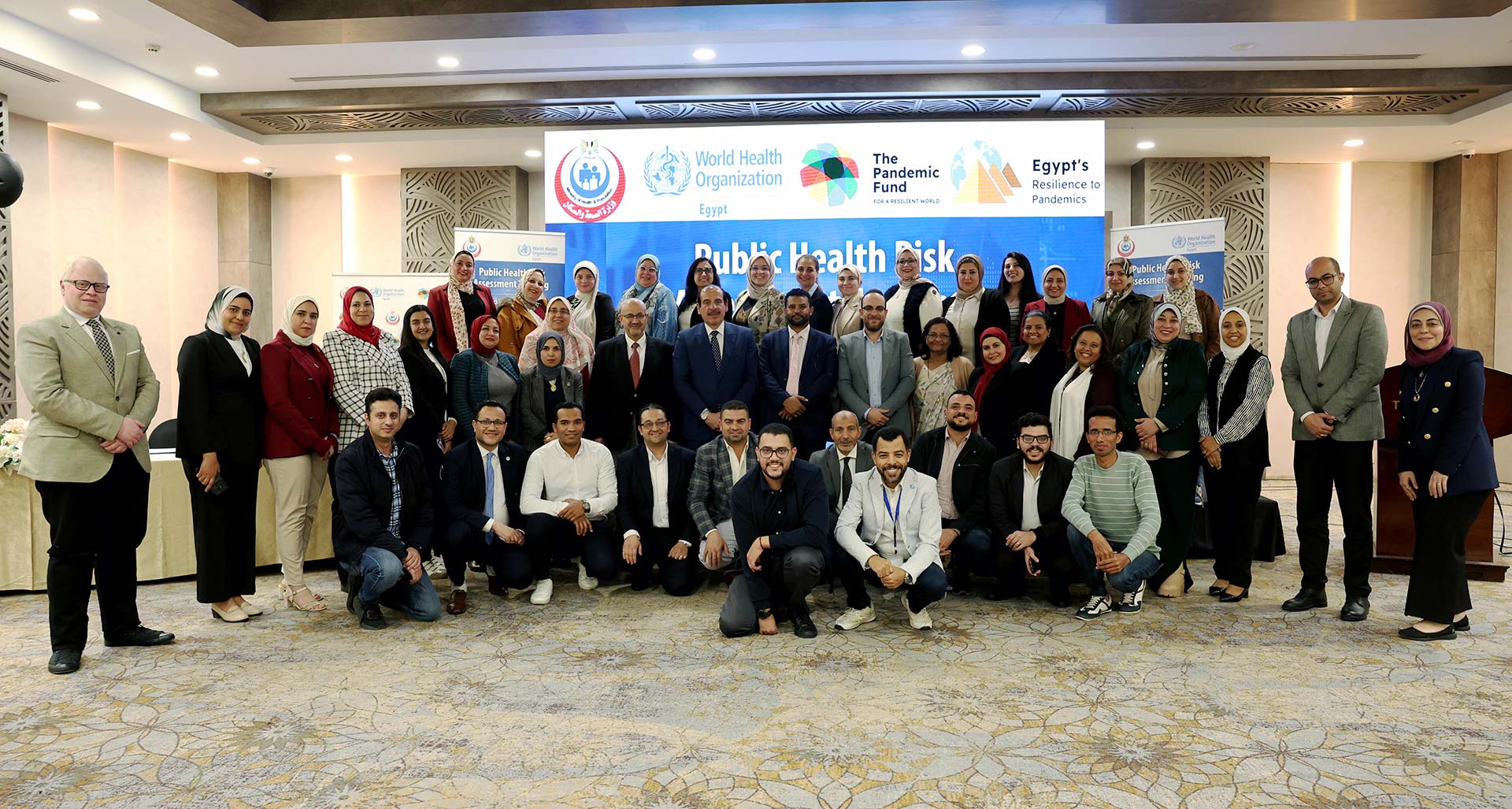Participants and facilitators, joined by the WHO Representative in Egypt and the Deputy Minister of Health, pose for a group photo during the closing session. Photo credit: WHO Egypt